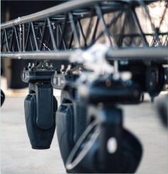 Professional concert stage lighting rig featuring pink and purple moving head beams and floor monitors by Jaycee Entertainment.