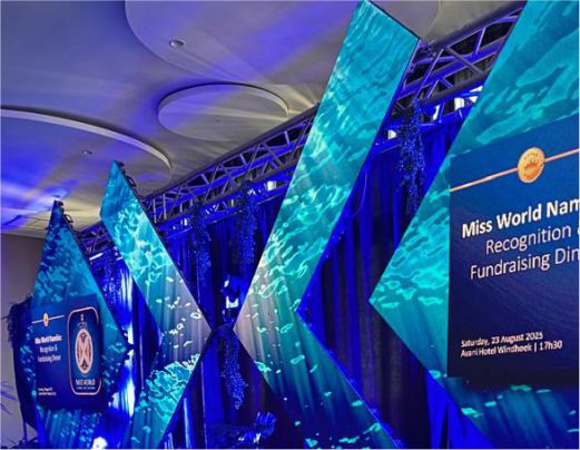 A modern stage setup with blue LED screens and water-ripple lighting for the Miss World Namibia Recognition and Fundraising Dinner at Avani Hotel Windhoek.